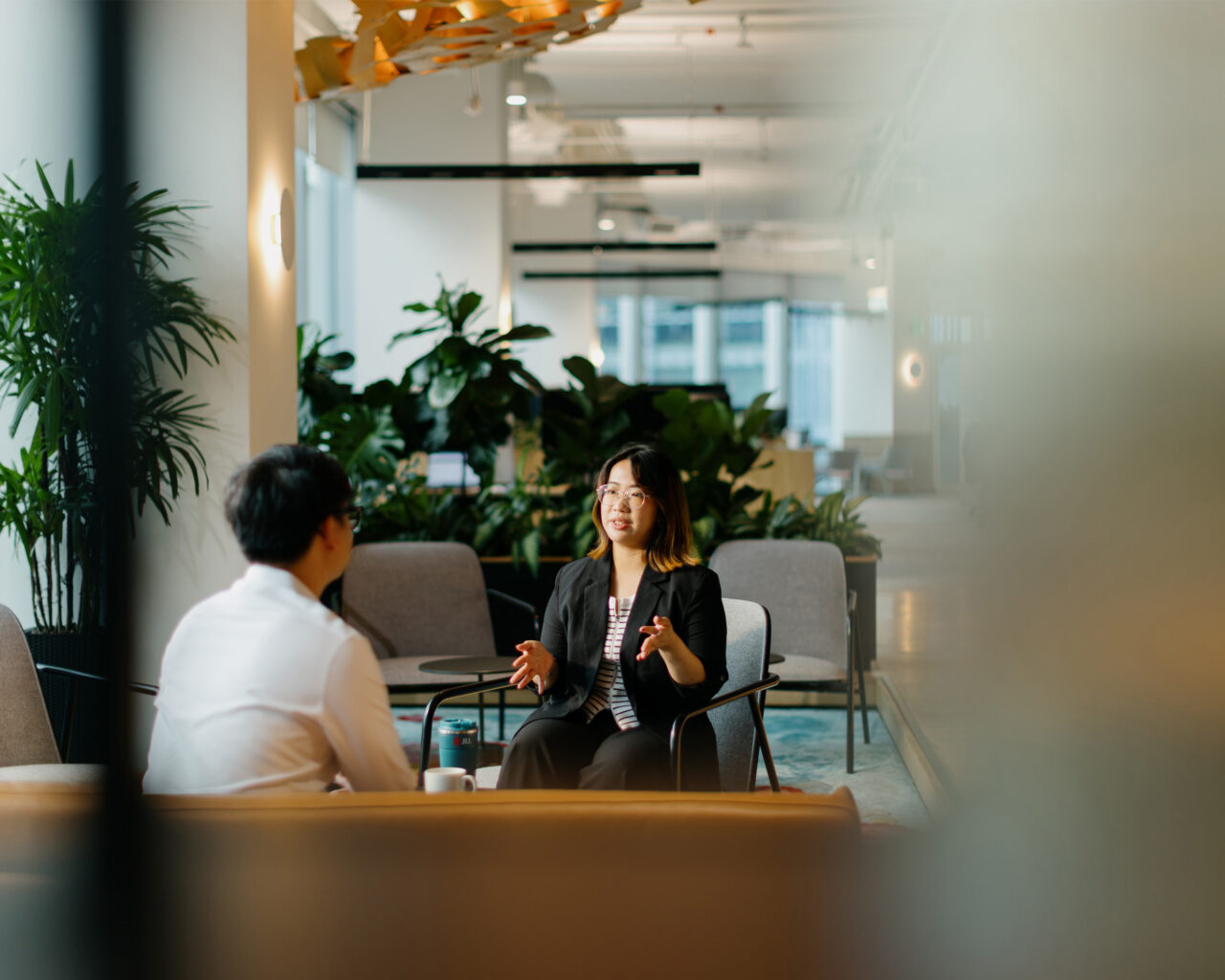 two people discussing in an open office space